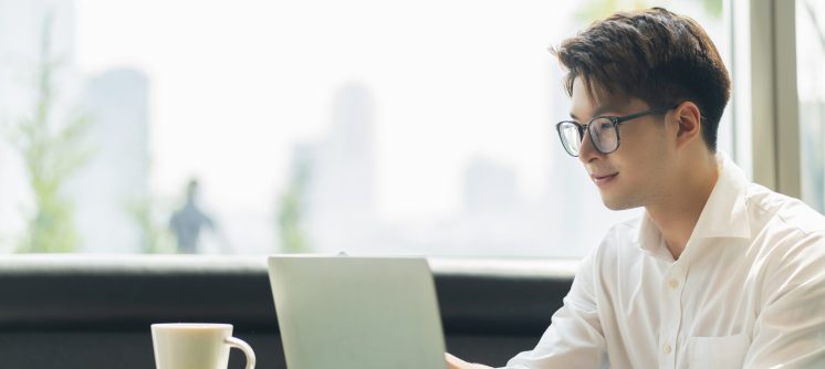 Smart attractive positive asian business male wearing glasses work remote new normal lifestyle hand use laptop tele conference onlive videocall meeting remote business ideas concept