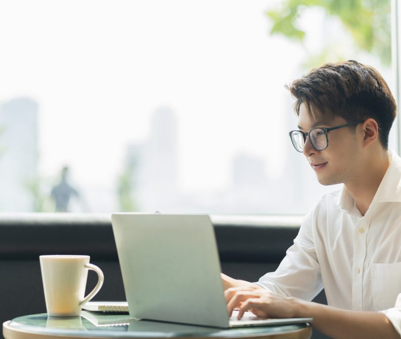 Smart attractive positive asian business male wearing glasses work remote new normal lifestyle hand use laptop tele conference onlive videocall meeting remote business ideas concept