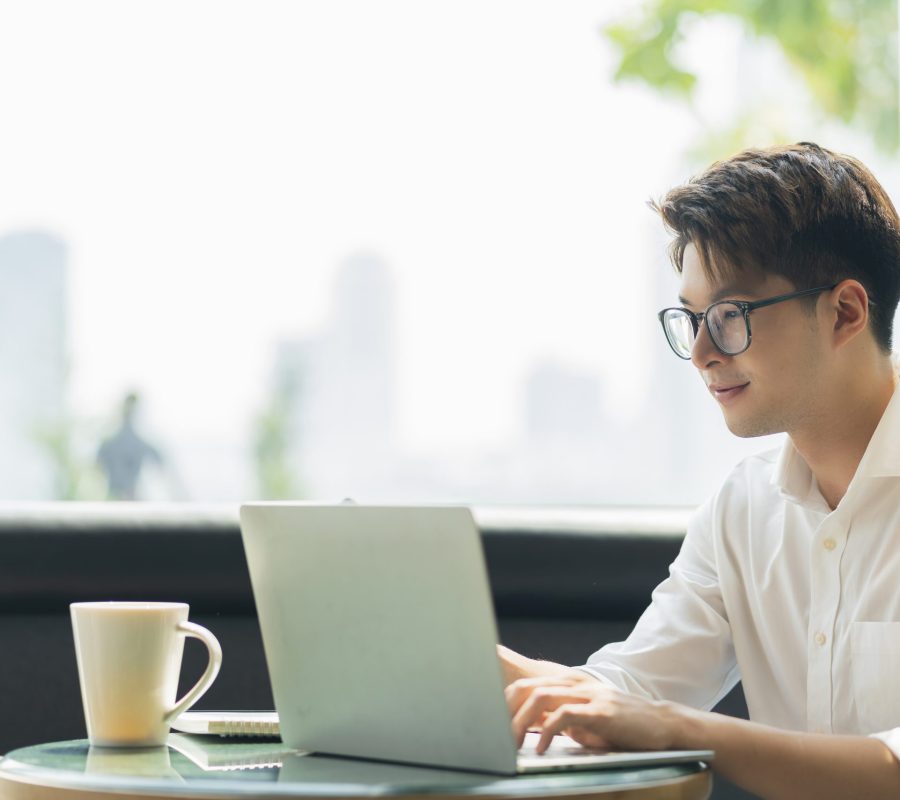 Smart attractive positive asian business male wearing glasses work remote new normal lifestyle hand use laptop tele conference onlive videocall meeting remote business ideas concept