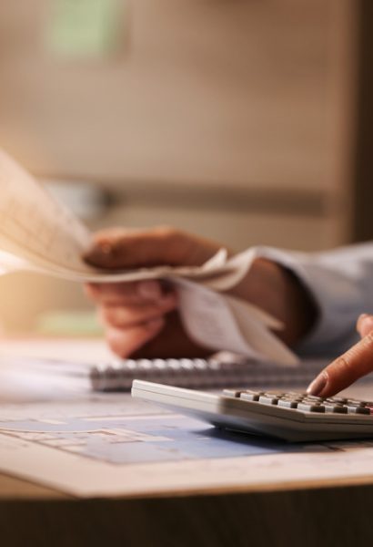 closeup-economist-using-calculator-while-going-through-bills-taxes-office (1)